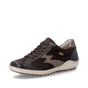 Du brun, une touche de bronze et beaucoup de personnalité! La Remonte R1443-25 est une chaussure pour femme qui combine l'élégance du suède et le confort d'une chaussure décontractée. Pourquoi on l'aime? Suède véritable : une belle finition douce et élégante. Semelle intérieure amovible : possibilité d'utiliser tes orthèses, selon leur volume. Lacets et fermeture éclair : pour ajuster la chaussure et l'enfiler facilement. Membrane RemonteTEX : aide à protéger les pieds de l'humidité. Doublure légèrement chaude : agréable pour les journées fraîches. Touches bronze : le petit détail qui fait toute la différence! Le conseil de Claudine : même si ce modèle est identifié en largeur G par Remonte, je le trouve plutôt étroit à l'essayage. Je le recommande davantage aux pieds fins ou réguliers qu'aux pieds larges. Une chaussure qui a du caractère, sans avoir besoin d'en faire trop!